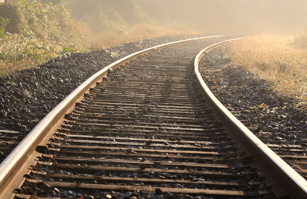 Image of train tracks and Bridgemark Strategies logo